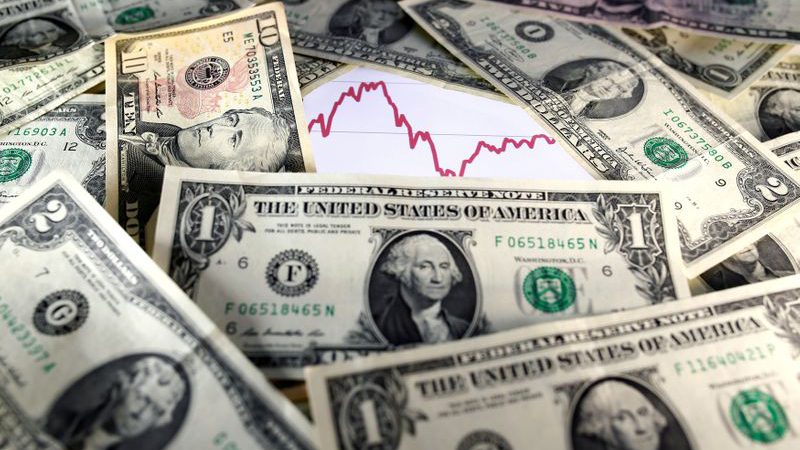 Dollar holds gains as investors cheer U.S. economic outlook